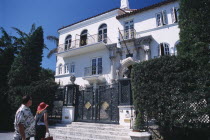 South Beach. Ocean Drive. Gianni Versace s Mansion Casa Casuarina. Man and woman viewing the front exterior from the bottom of entrance stepsAmerican North America United States of America Beaches R...