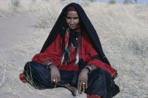 Portrait of nomadic Bororo lady with braided hair and traditional jewellery.