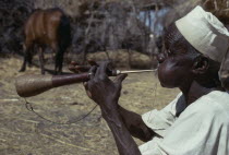 Musician playing a shawm  a traditional double reed instrument