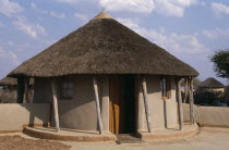 Traditional circular hut with thatched roof.