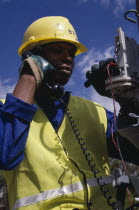 Portrait of trainee electrical engineer working on terminal box.