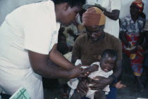 Child receiving vaccination from female nurse.innoculation injection African Children Eastern Africa Kids Zimbabwean