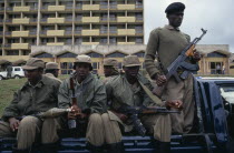 RPF Troops outside parliament building carrying guns and rocket launchers