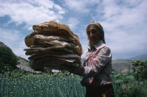 Woman holding pile of lavash  the local bread.Armenian Asia Asian Female Women Girl Lady Middle East Female Woman Girl Lady
