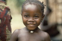 Head and shoulders portrait of young Mende girl smiling .