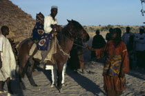 Arranged marriage mock abduction with fourteen year old bride taken away on horseback by her new husband to his village.