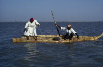 Two Buduma tribesmen fishing in a reed boat on the lake
