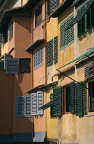 Ponte Vecchio. Facades of colourful buildings with detail of wooden shutters seen in golden lightColorful European Firenze Italia Italian Southern Europe Toscana Tuscan