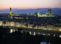 View over city at dusk with the Duomo illuminated and street lights reflected in the River Arno.Firenze Italia Italian Religion Southern Europe European Religious Toscana Tuscan