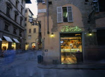 Ice cream bar with neon sign illuminated at night in narrow street with pedestrians in blurred movement. Firenze Inn Italia Italian Nite Pub Southern Europe Tavern European Public House Toscana Tusca...