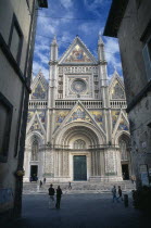 The Duomo facade partly viewed through a narrow street.Italia Italian Religion Southern Europe European Religious