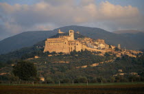 View of the Basilica di San Francesco and Assisi on hillside with hills behind.Italia Italian Religion Southern Europe European Religious