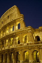 The Colosseum exterior view at night of floodlit walls set against dark sky. Blue European History Italia Italian Nite Roma Southern Europe