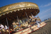Children enjoying Carousel ride on Brighton beachEuropean Great Britain Northern Europe UK United Kingdom British Isles Beaches Kids Resort Sand Sandy Seaside Shore Tourism