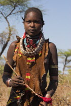 Dombo village  Hamer lady holding spoon she has used to stir cows bood ready for drinking