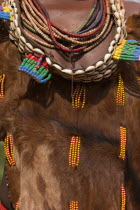 Womans necklaces and traditional goatskin dress decorated with cowrie shells