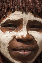 Banna woman  her hair greased with ocher colouring and animal fat into plaits known as Goscha