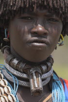 Banner woman wearing a necklace know as a Bignere - an metal band with a phallic protuberance to signify that she is a first wife