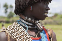 Banner woman wearing a necklace know as a Bignere - an metal band with a phallic protuberance to signify that she is a first wife