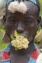 Tsemay man with flower in mouth at weekly marke