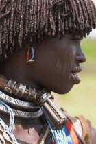 Weekly market  Banner woman wearing a necklace know as a Bignere - an metal band with a phallic protuberance to signify that she is a first wife