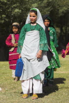 Aimaq nomad camp  Women and girl carry containers that they filled with water from river  fetching water is usually the job of women/girls here    The Aimaq are semi nomadic people who move out of the...