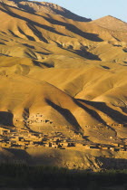 Late afternoon sun glows on mountains and village