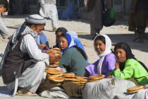 Man buying bread from girls