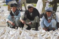 Man feeding famous white pigeons at Shrine of Hazrat Ali  who was assissinated in 661 This shrine was built here in 1136 on the orders of Seljuk Sultan Sanjar  destroyed by Genghis Khan and rebuilt b...