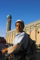 Boy outside the Friday Mosque or Masjet-eJamOriginally laid out on the site of an earlier 10th century mosque in the year 1200 by the Ghorid Sultan Ghiyasyddin. Restoration started in 194