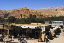 Main road in town infront of empty niche in cliffs where the famous carved large Budda once stood 180 foot high before being destroyed by the Taliban in 200