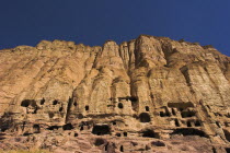 Caves in cliffs near empty niche where the famous carved small Budda once stood 180 foot high before being destroyed by the Taliban in 2001