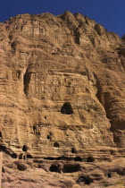Caves in cliffs near empty niche where the famous carved small Budda once stood 180 foot high before being destroyed by the Taliban in 2001