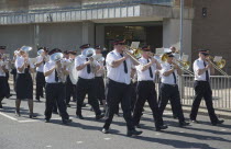 The Salvation Army Band marching along seafront in the summer.