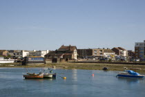 View across the river Adur from the footbridge toward the Waterside Inn pub on Shoreham Beach.