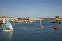 People sailing their dingies in the river Adur next to the marina.
