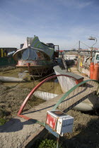 Houseboat moored along the banks of the river adur.  Former barges converted into homes with the use of various bits of junk  including cars  buses and washing machines.