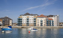 Ropetackle modern housing development apartments on the banks of the river Adur seen from the opposite bank.. A regenerated brownfield former industrial area.