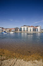 Ropetackle modern housing development apartments on the banks of the river Adur seen from the opposite bank.. A regenerated brownfield former industrial area.