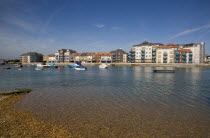 Ropetackle modern housing development apartments on the banks of the river Adur seen from the opposite bank.. A regenerated brownfield former industrial area.