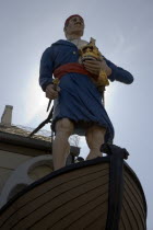 Exterior of the Crown and Anchor public house in the high street with ships mast head figure in the fonrt of the building.