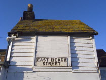 East Beach Street sign on white wooden building