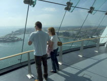 Gunwharf Quays. The Spinnaker Tower. Interior view with visitors looking out of glass windows on the top observation deck  providing a 320 view of the city of Portsmouth  the Langstone and Portsmouth...