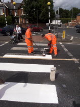 White lines being painted on Zebra Crossing.