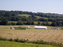 Battle Abbey. Field where the Battle of Hastings took place in 1066. People setting up a historical re-enactment on grass near marquees.