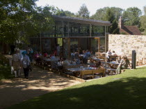 Battle Abbey. Modern cafe in abbey grounds with visitors at outside seating