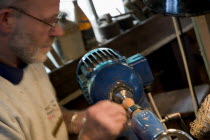 Amberley Working Museum. The West Sussex Woodturners with a man working at Machinery  demonstrating traditional wood-working tools and skills