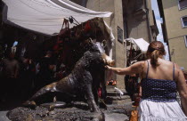 Mercato Nuovo. Fontana del Porcellino. Bronze fountain of a boar with a woman rubbing the snout for good luck