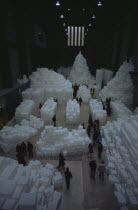 Tate Modern. Turbine Hall. Exhibition by Rachel Whiteread called Embankment. 14 000 transluscent white polyethylene boxes stacked in various ways.View looking down over visitors walking around exhibi...