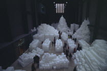 Tate Modern. Turbine Hall. Exhibition by Rachel Whiteread called Embankment. 14 000 transluscent white polyethylene boxes stacked in various ways.View looking down over visitors walking around exhibi...